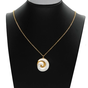 Golden spiral shell pendant necklace with white enamel on a black jewelry neck display