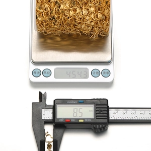Gold stainless steel heart link chain for DIY jewelry making on a roll with scale