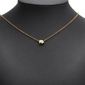 Minimalist gold-plated stainless steel necklace with elephant pendant on black display