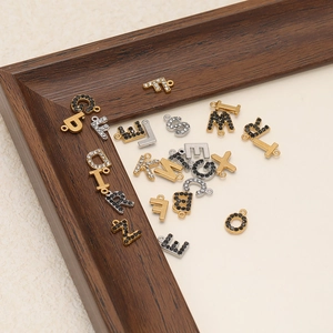 Alphabet charms in gold and silver finish with sparkling cubic zirconia for DIY jewelry