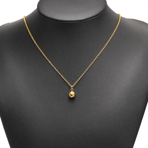 Polished gold faceted ball pendant with hammered texture on a fine cross chain necklace