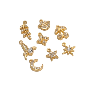 Set of 8 gold stainless steel charms with rhinestones featuring stars, birds and hearts