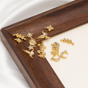 Gold stainless steel charms with crystal inlay shown from a 45-degree angle