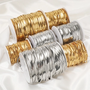 Golden and silver stainless steel flat herringbone snake chains on white reels