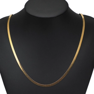 Polished gold flat herringbone snake chain necklace displayed on a black jewelry stand