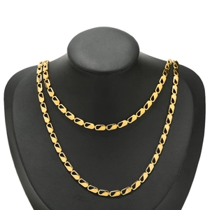 Detail view of gold-plated rectangular chain links displayed on a black neck model