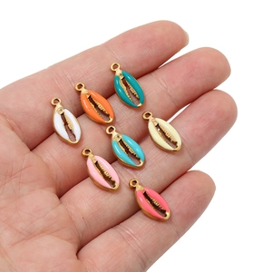 Colorful shell-shaped stainless steel charms with gold plating held in palm