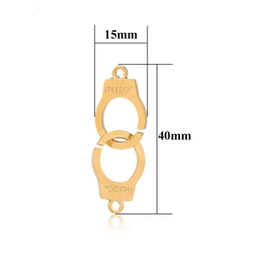 Detailed macro view of freedom engraved gold handcuff charms with 40mm size dimensions