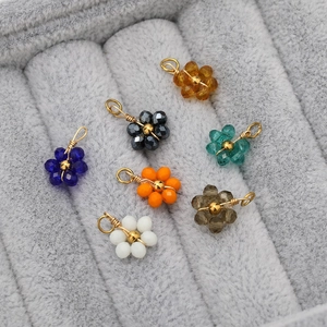 Close-up of handmade crystal flower pendants in various colors for DIY jewelry making
