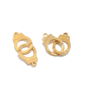 Detailed close-up of golden stainless steel freedom handcuff charms for DIY jewelry