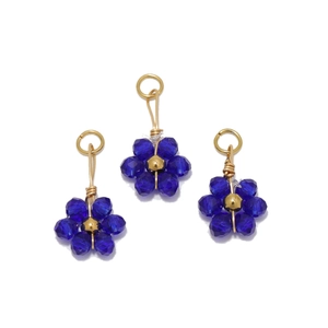 Detailed view of three blue crystal flower pendants with gold bead centers for DIY jewelry