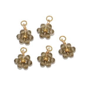 Detailed view of five grey crystal flower pendants with gold wiring for DIY jewelry making