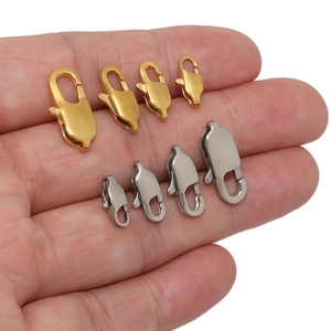 Gold and silver lobster clasps in four sizes displayed on hand for jewelry making