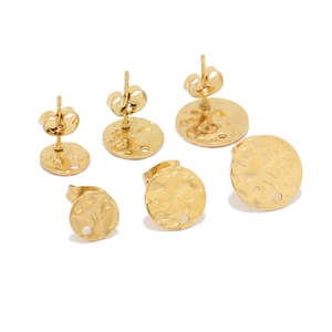 Detailed macro view of gold hammered round stud earring components for DIY jewelry making