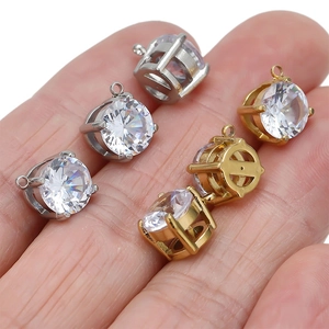 Detail of 7mm round white zircon charms in gold and silver finish for DIY jewelry