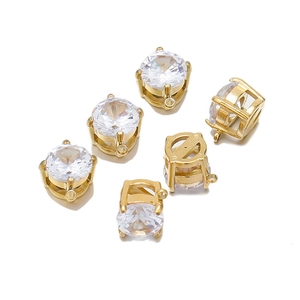 Macro shot of 7mm round gold-plated stainless steel pendants with clear cubic zirconia settings