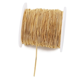 Detailed close-up of 1.8mm golden stainless steel Cuban chain on a white spool