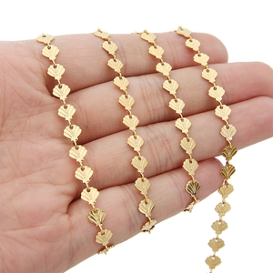 6mm gold-plated stainless steel shell link chain necklace held in hand on white background