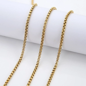 Golden stainless steel box chain necklace 3mm width wrapped around a white cylinder base