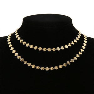 Detail of 18k gold plated stainless steel necklace with shell shaped fan links on a bust