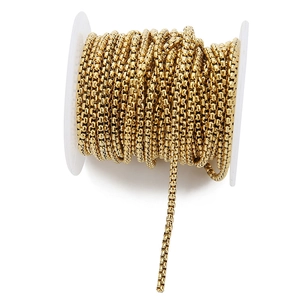 Detailed close-up of 18k gold plated stainless steel box chain on white spool