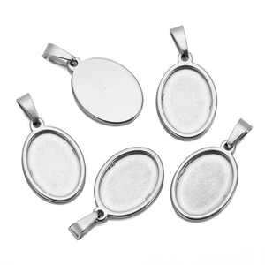 Detailed macro view showing five stainless steel oval pendant trays with bails for DIY jewelry