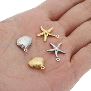 Detailed view of hollow starfish and seashell charms for DIY necklaces and jewelry making
