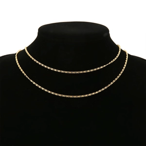 Close-up of 18K gold-plated stainless steel paperclip chain on a black jewelry display