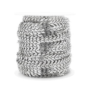 Detailed macro view of 6mm silver leaf chain links wound on a spool for DIY jewelry making