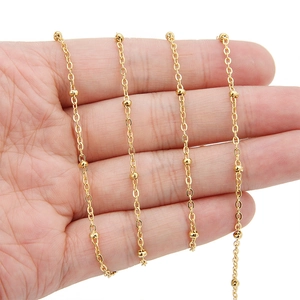 Close-up of 18k gold plated 2mm stainless steel bead chain and delicate O-link chain
