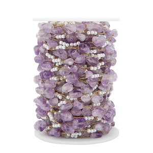 Dettaglio catena per gioielli fai-da-te con pietre naturali viola e perle su bobina