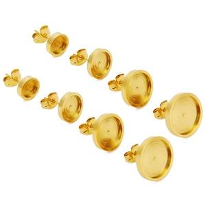 Macro view of gold stainless steel bezel cup earring studs with butterfly backs