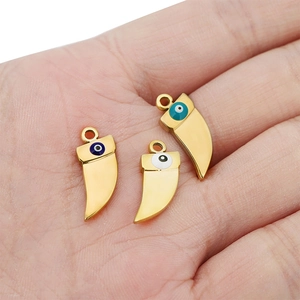Three gold stainless steel evil eye horn pendants in blue, turquoise, and white colors