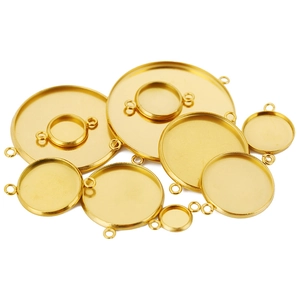 Detail of round gold stainless steel pendant trays with dual loops for DIY jewelry making