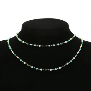Double-layered gold chain necklace with green crystal square beads and gold round beads