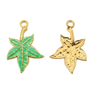 Macro detail of leaf-shaped stainless steel charms with green enamel and gold finish