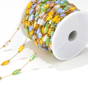 1mm gold stainless steel chain with colorful faceted beads on white spool