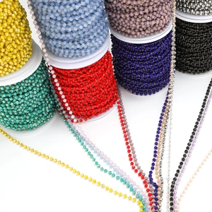 Macro shot of 3mm colorful faceted crystal beads on gold-plated stainless steel chain