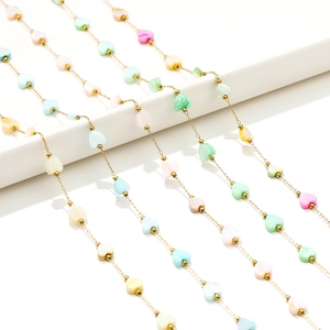 Detailed macro view of 6mm colorful shell heart pendants on gold-plated stainless steel chains