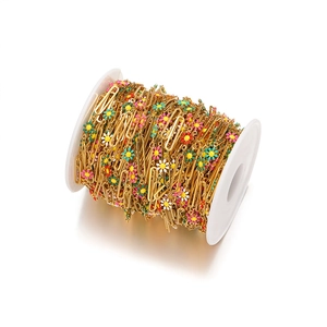 Detail of multi-color enamel daisy charms on 18k gold-plated paperclip chain on a spool