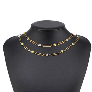Gold-plated stainless steel chain with colorful daisy enamel charms on a black neck bust