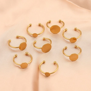 Set of eight adjustable gold plated stainless steel ring blanks with flat round base