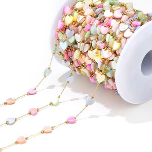 Close-up of 6mm multicolor shell heart beads with gold spacer beads for DIY jewelry