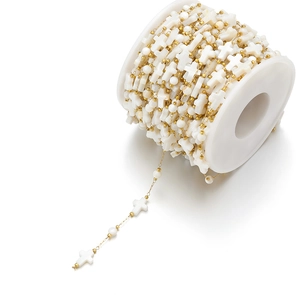 Close-up of 8mm shell cross beads on 18k gold-plated stainless steel chain roll
