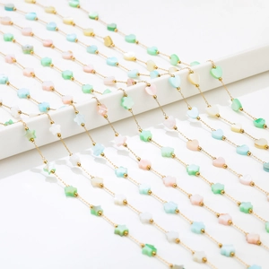 Detailed shot of 1mm gold snake chain with colorful resin heart and flower bead charms