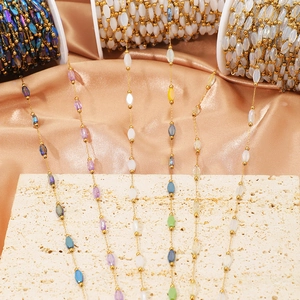 Detail of colorful oval crystal beads and gold stainless steel chain for DIY jewelry making