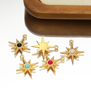 Gold stainless steel star pendants with colorful natural stones on a mirror surface