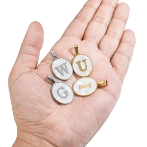 Oval alphabet pendants with white shell inlay in gold and silver metal frames for DIY necklaces
