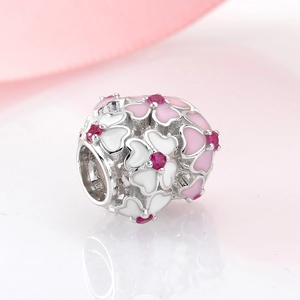 Macro detail of S925 sterling silver four-leaf clover charm with pink and white enamel petals