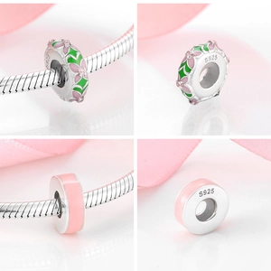 Macro detail of S925 sterling silver pink flower and donut charms for DIY bracelets